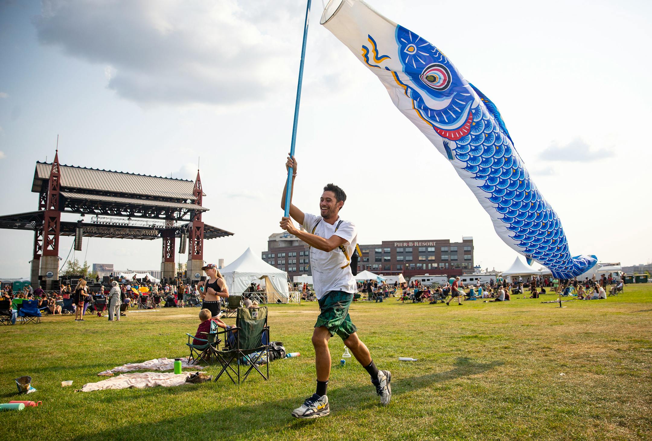 A festival goer ran around Bayfront Festival Park with fish wind streamers at the Water is Life Festival on Wednesday.