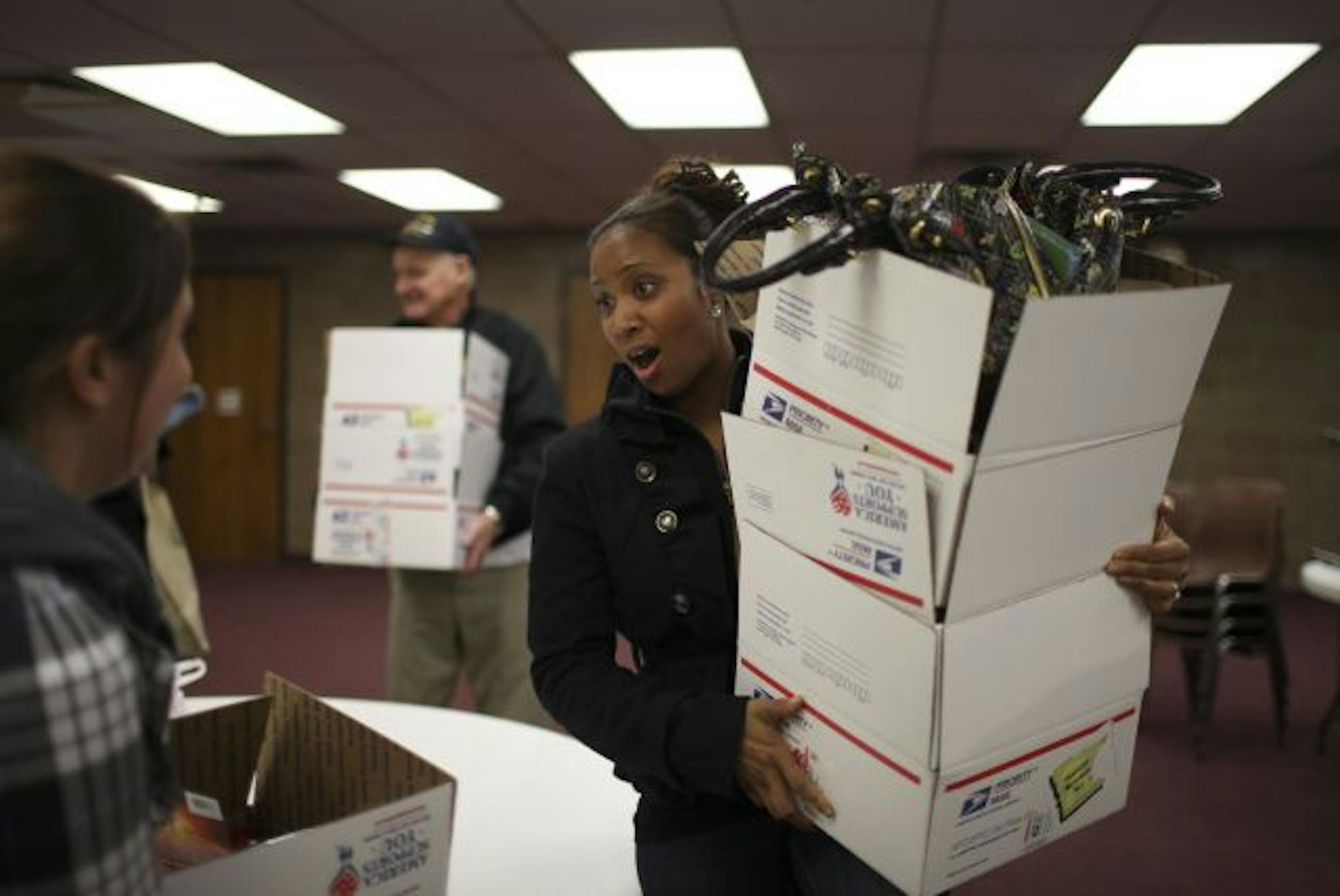 Bernice Morris held boxes of goodies she packed for soldiers as part of Operation Minnesota Nice.