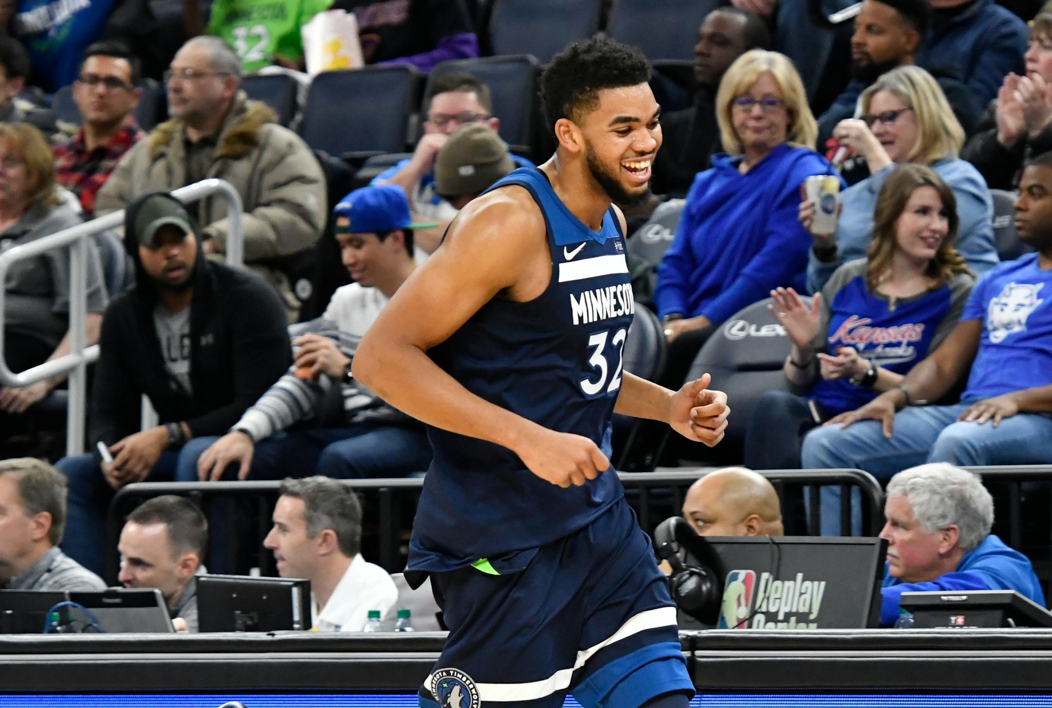 Minnesota Timberwolves' Karl-Anthony Towns smiles on his way to the bench as he is relieved late in the second half of an NBA basketball game against the Los Angeles Lakers Monday, Jan. 1, 2018, in Minneapolis.The Timberwolves won 114-96.