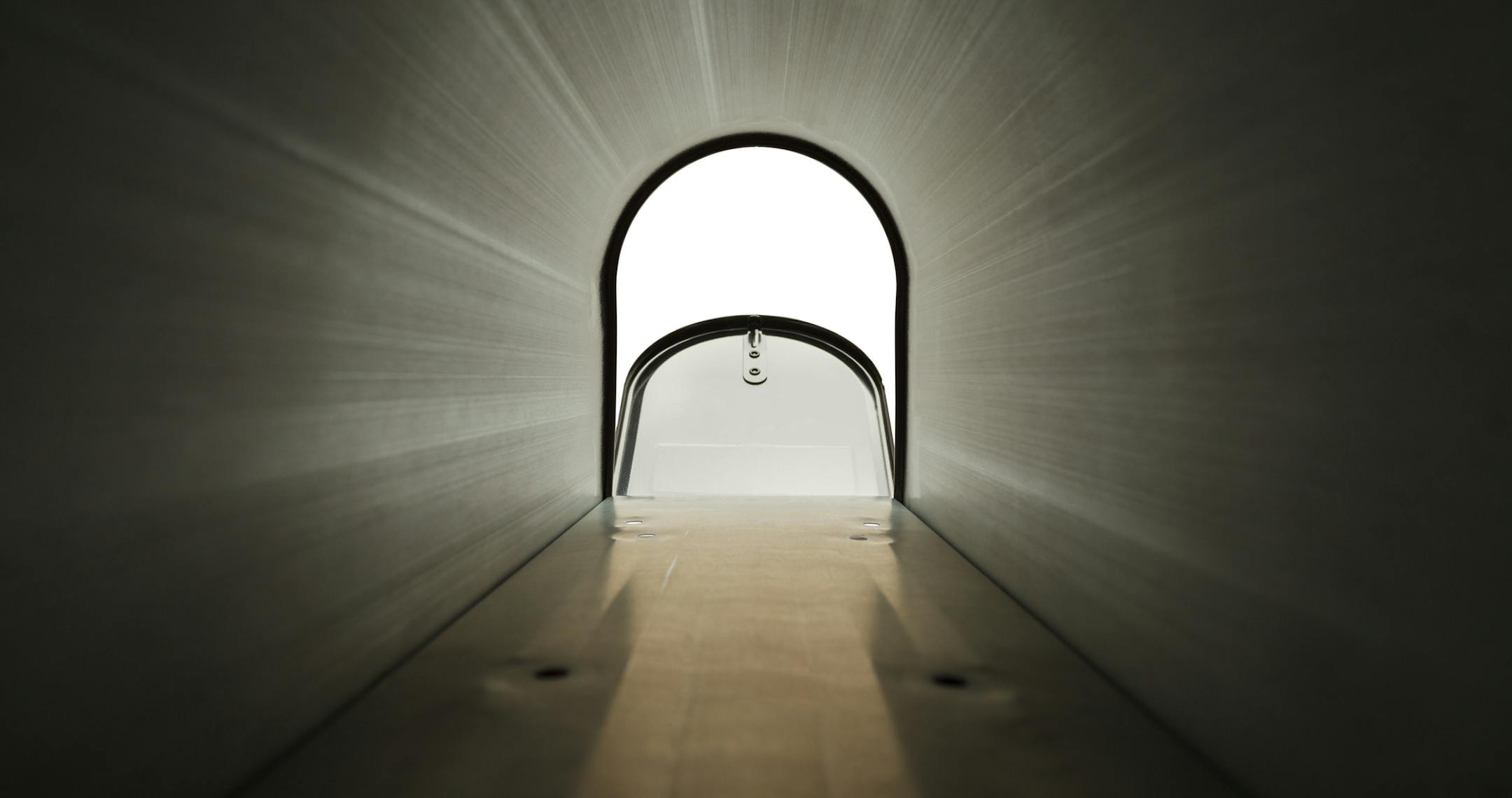 Inside Black Metal Mailbox Looking Out Isolated on White Background.