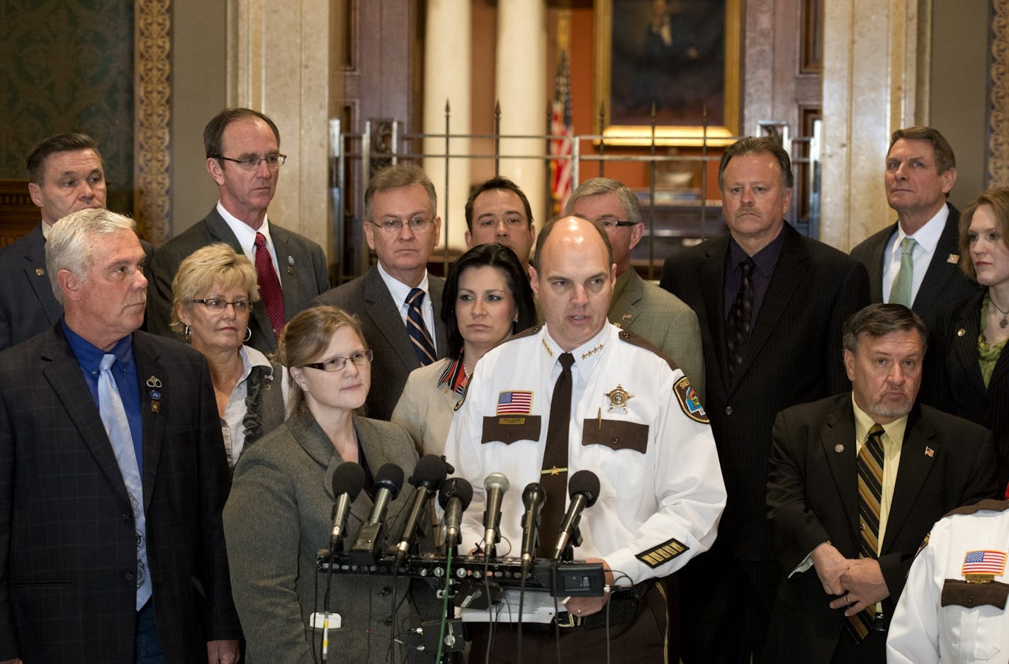 A bipartisan group of lawmakers and members of the Minnesota Sheriff's Association stood in front of the House chambers to introduce an alternative gun bill that doesn't include background checks. The bill's author is Rep. Debra Hilstrom, center and is supported by Sen Tony Cornish, left, a gun rights advocate and Hennepin County Sheriff Rich Stanek, center.