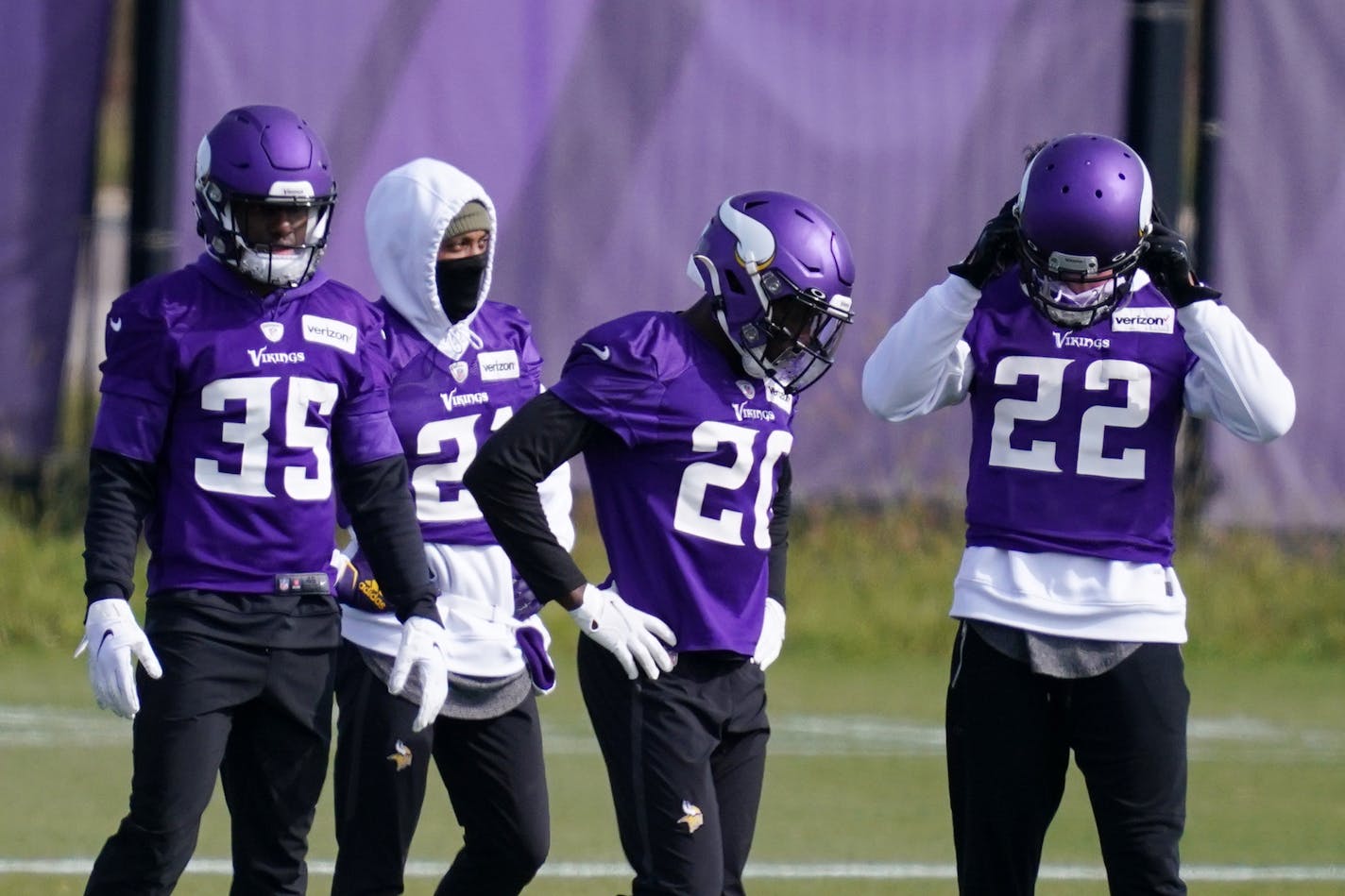 Minnesota Vikings cornerback Jeff Gladney (20) stood with his teammates Friday.