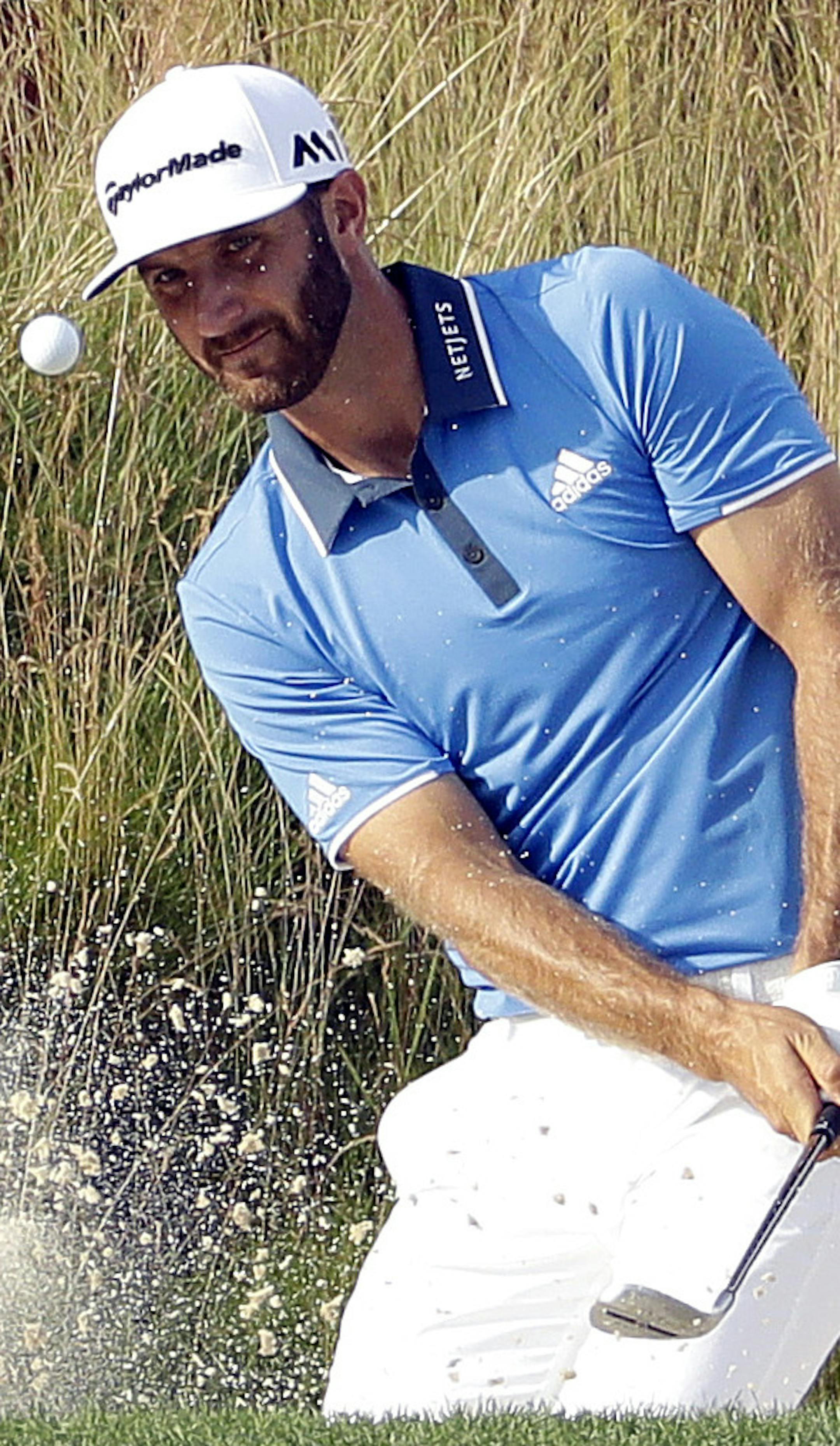 Dustin Johnson hits out of the bunker on the fifth hole during third round of the U.S. Open golf championship at Oakmont Country Club on Saturday, June 18, 2016, in Oakmont, Pa. (AP Photo/Charlie Riedel)