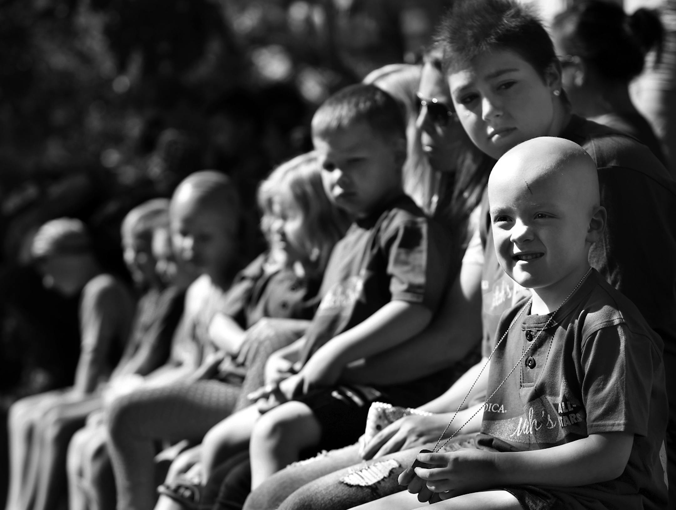 “Mitch’s All-Stars”, almost 50 kids battling cancer, sit at the front of the stage at the Miracle for Mitch kids triathlon at Lake Nokomis in Minneapolis, Minn., on Saturday, August 3, 2013.