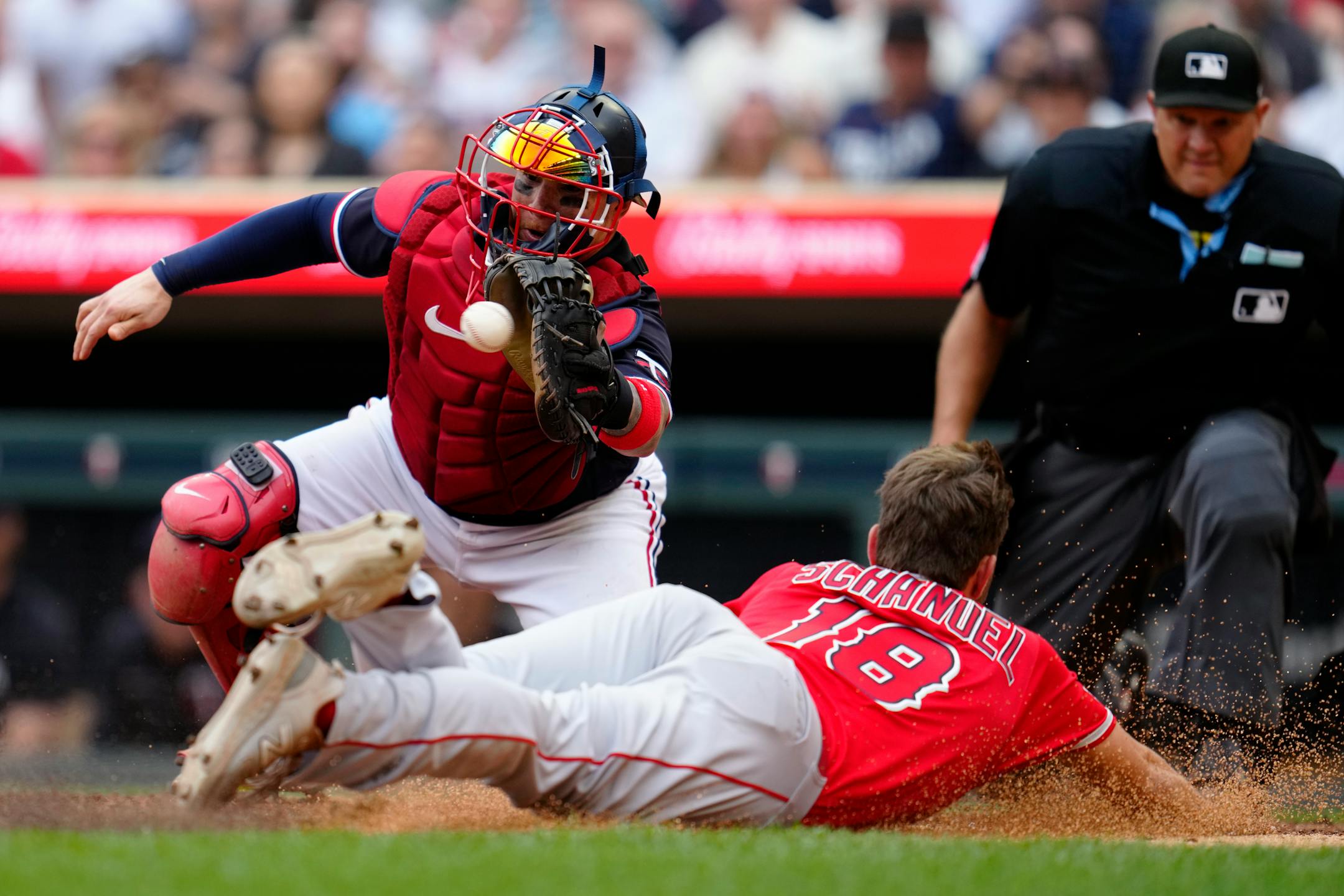 Minnesota Twins catcher Christian Vazquez catches a pass to tag out Los Angeles Angels' Nolan Schanuel during the eighth inning of a baseball game, Saturday, Sept. 23, 2023, in Minneapolis. (AP Photo/Abbie Parr)