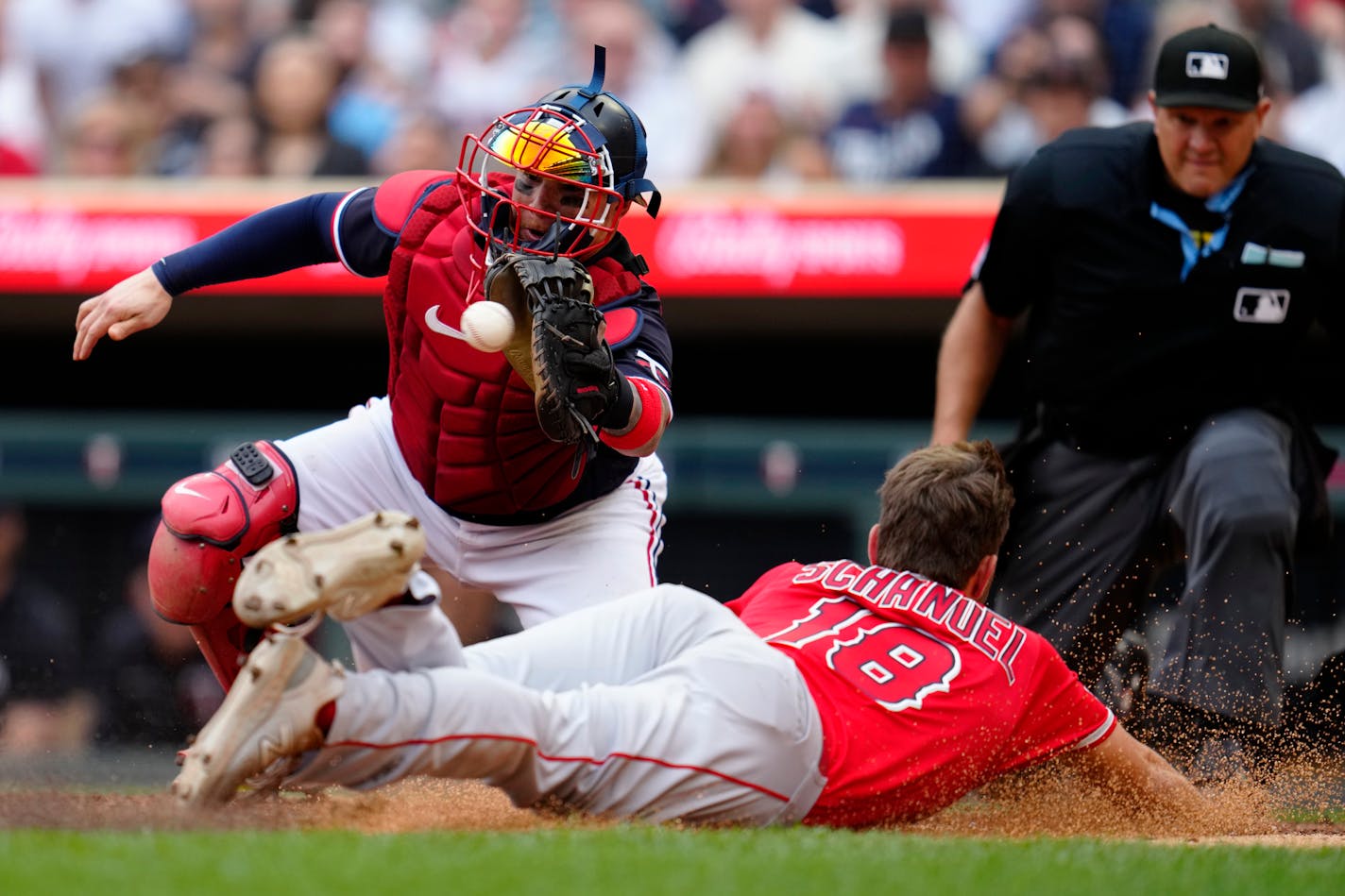 Minnesota Twins catcher Christian Vazquez catches a pass to tag out Los Angeles Angels' Nolan Schanuel during the eighth inning of a baseball game, Saturday, Sept. 23, 2023, in Minneapolis. (AP Photo/Abbie Parr)