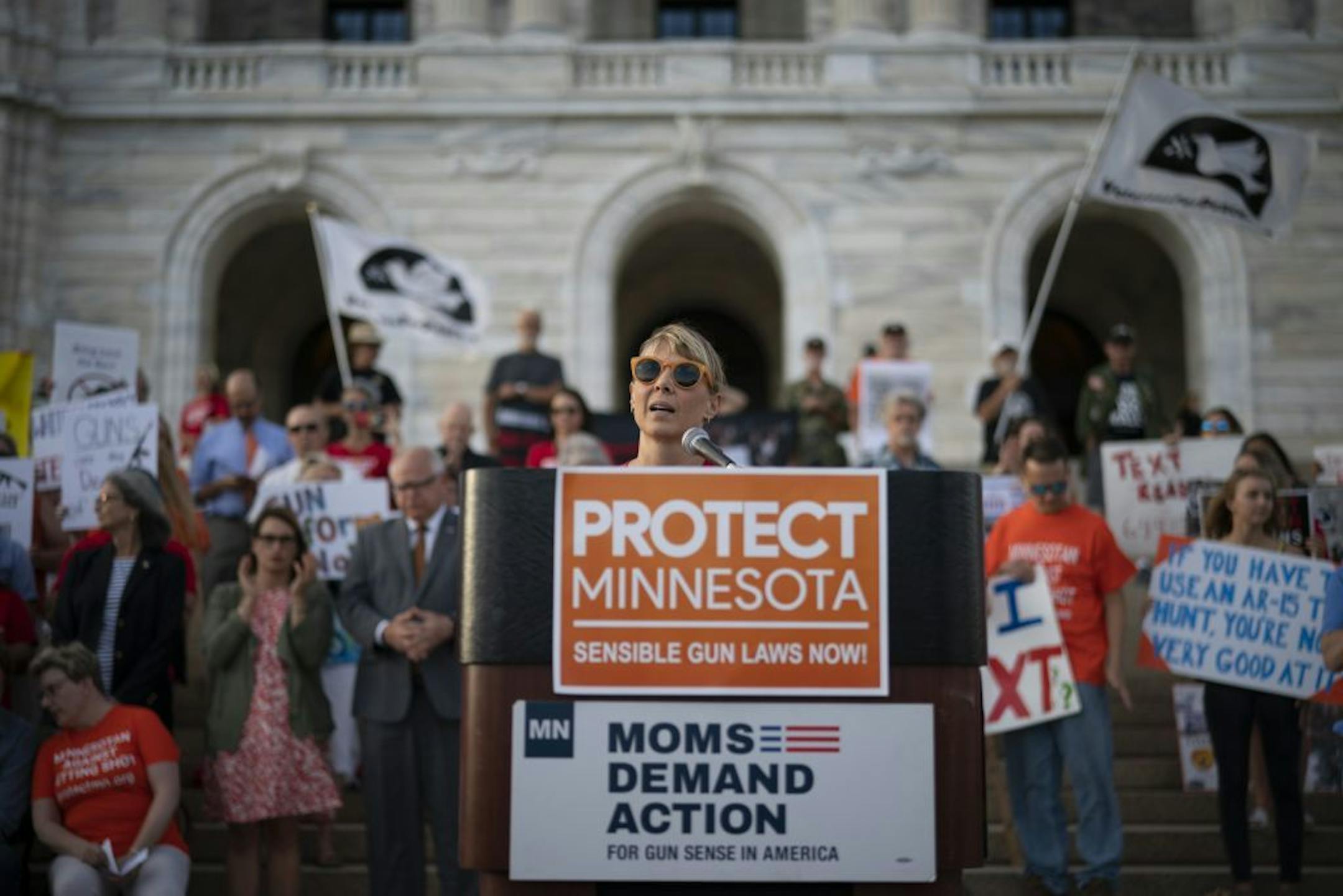 "The metaphor sort of being used right now is that you're at the airport, there's two lines and one is security and one is not," said Molly Leutz, a leader for Moms Demand Action Minnesota. "That in a way is where we are with gun sales in Minnesota." Leutz, above, addressed a crowd at a rally Aug. 7 at the state Capitol.