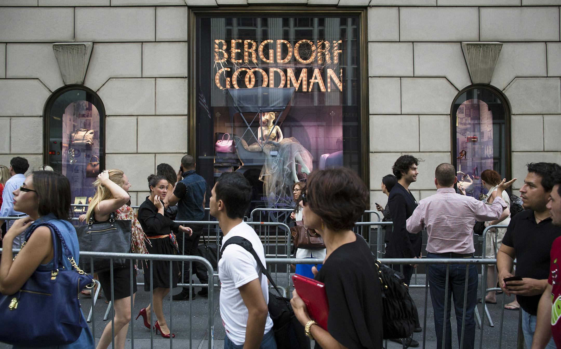 Shoppers line up to enter Bergdorf Goodman during Fashion's Night Out on Fifth Avenue, Thursday, Sept. 6, 2012, in New York. Fashion's Night Out is a global event created to restore consumer confidence and boost the economy of the fashion industry. (AP Photo/John Minchillo) ORG XMIT: NYJM112