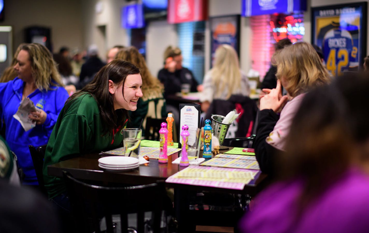 Kaley Heyda, left, playing bingo with Teresa Palmen, is convinced of catastrophic scenarios painted by some Trump critics — of American democracy crumbling, or the sparking of international conflict.