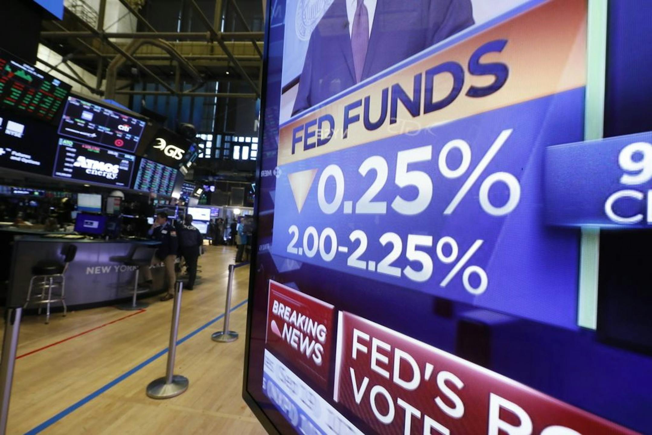 A television monitor on the floor of the New York Stock Exchange headlined the rate decision of the Federal Reserve. Stocks fell in response as investors were uncertain about the likelihood of additional rate cuts.