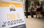 Free COVID-19 vaccine and testing signage is displayed during a public health mobile vaccination clinic at the California State University Long Beach 