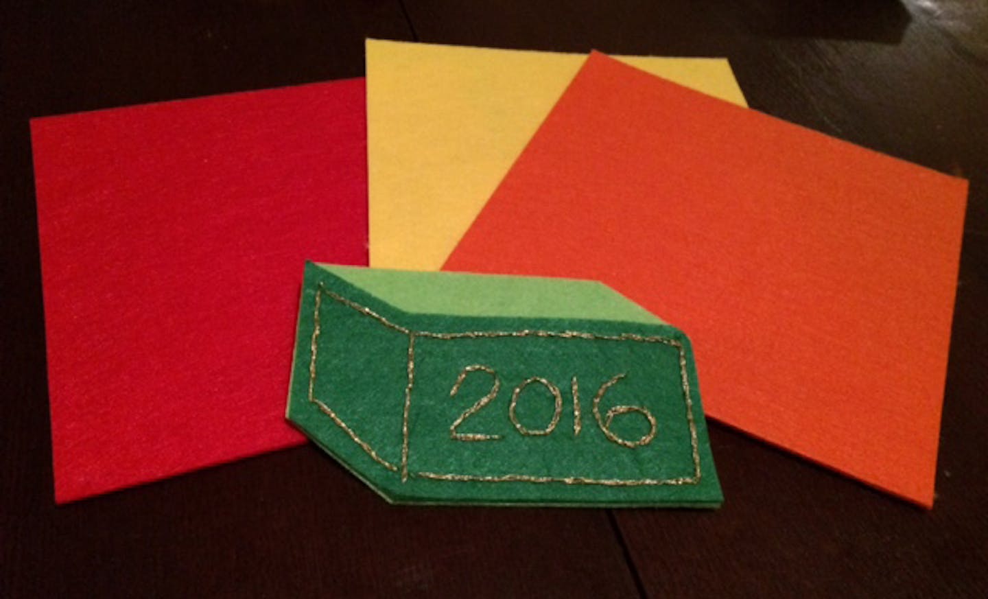 Part of step-by-step instructions for crafting a felt dumpster fire holiday ornament.