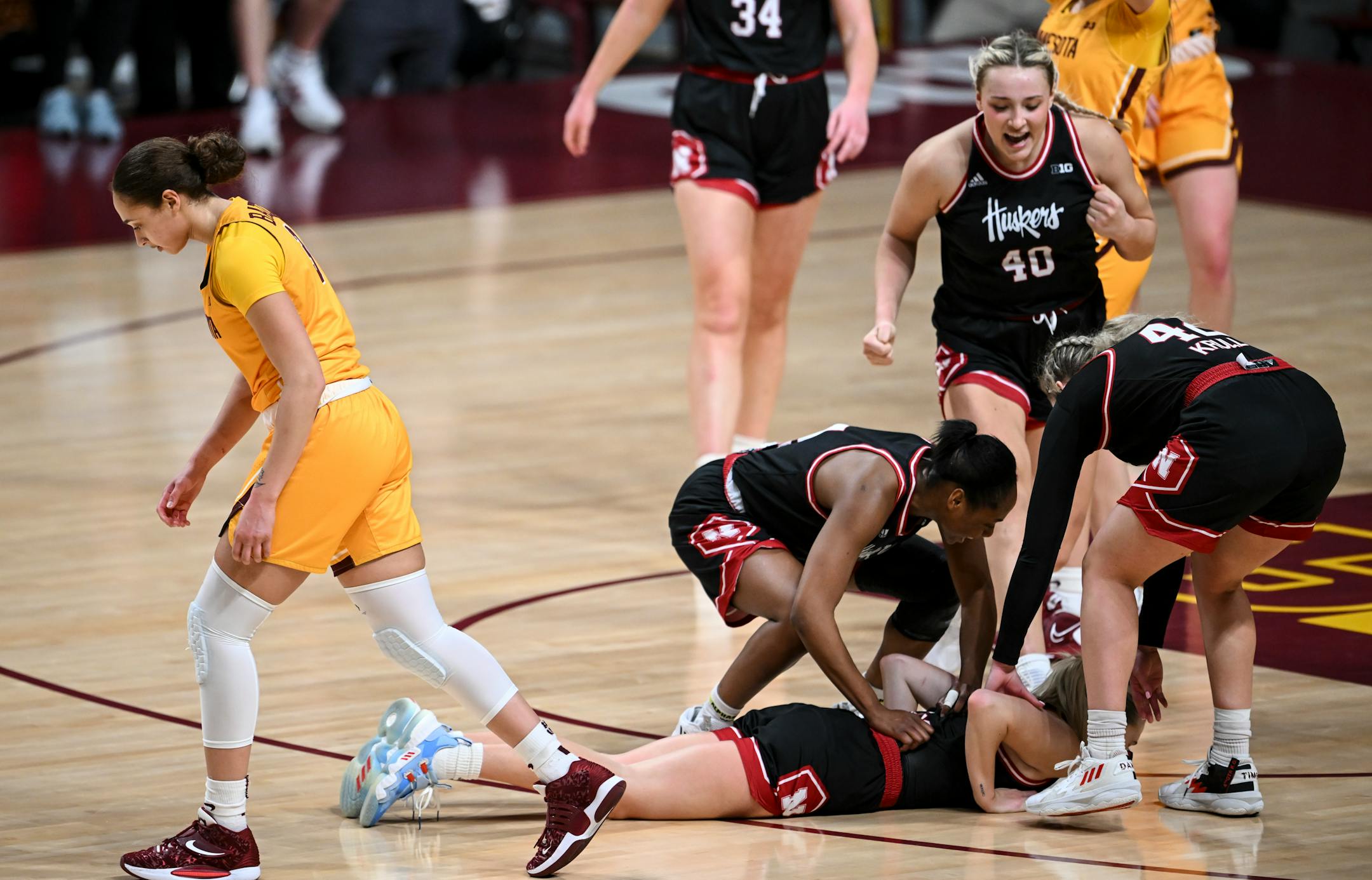 Minnesota guard Amaya Battle (3) walks back to the gench after fouling out while unsuccessfully defending a made 3-point shot by Nebraska guard Jaz Shelley (1) during the fourth quarter.