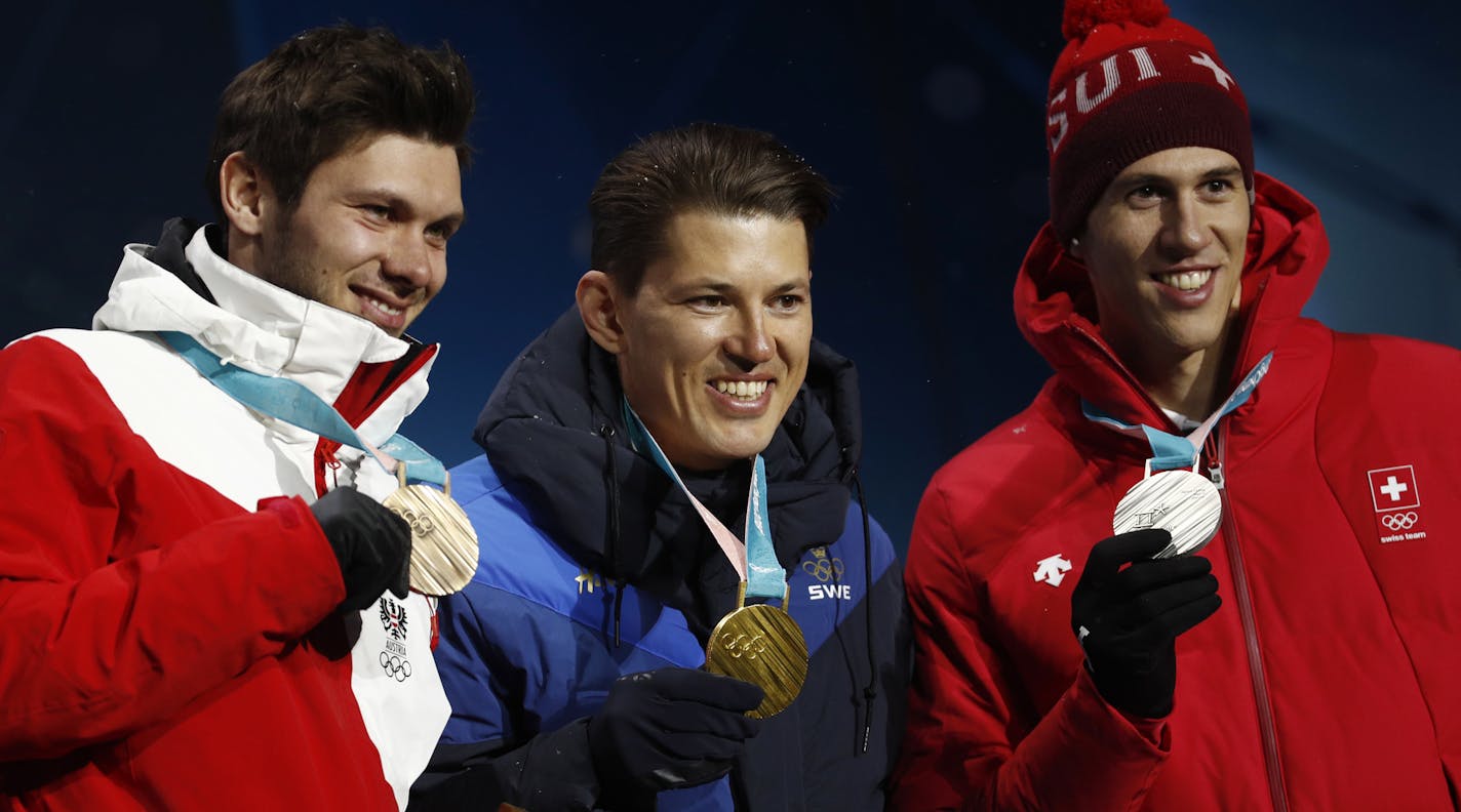 Medalists in the men's slalom, from right, Switzerland' Ramon Zenhaeusern, silver, Sweden's Andre Myhrer, gold, and Austria's Michael Matt, bronze, pose during their medals ceremony at the 2018 Winter Olympics in Pyeongchang, South Korea, Thursday, Feb. 22, 2018. (AP Photo/Patrick Semansky)