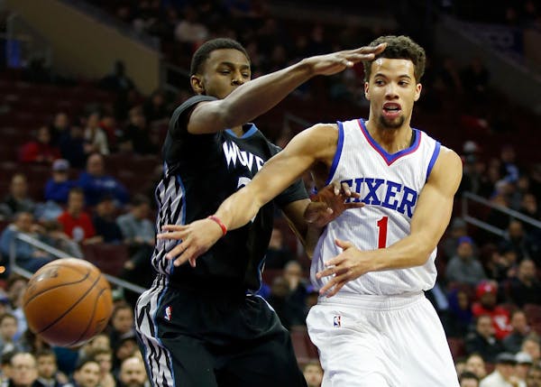 The Philadelphia 76ers' Michael Carter-Williams passes around the Minnesota Timberwolves' Andrew Wiggins during the first quarter at the Wells Fargo C