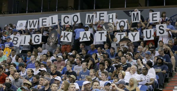 Minnesota Timberwolves fans cheer for rookie Timberwolves guard Tyus Jones during an NBA basketball scrimmage in Minneapolis, Wednesday, July 8, 2015.