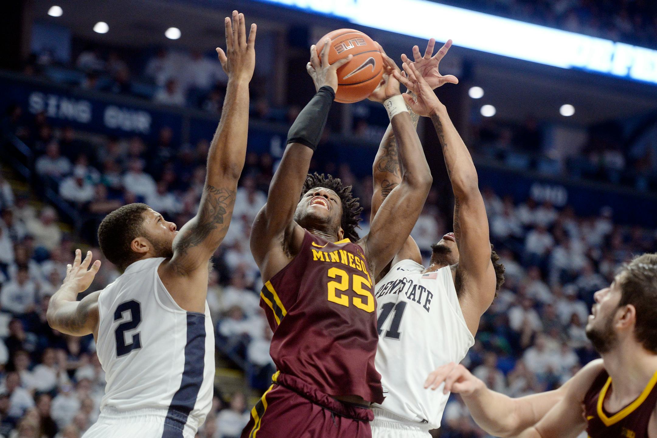 Minnesota's Daniel Oturu shoots between Penn State's Myles Dread (2) and Lamar Stevens (11) during second-half action