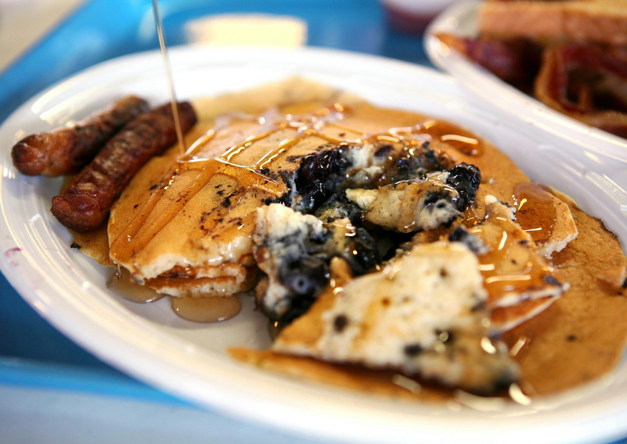 Blueberry pancakes with sausage at the OES Dining Hall at the Minnesota State Fair .