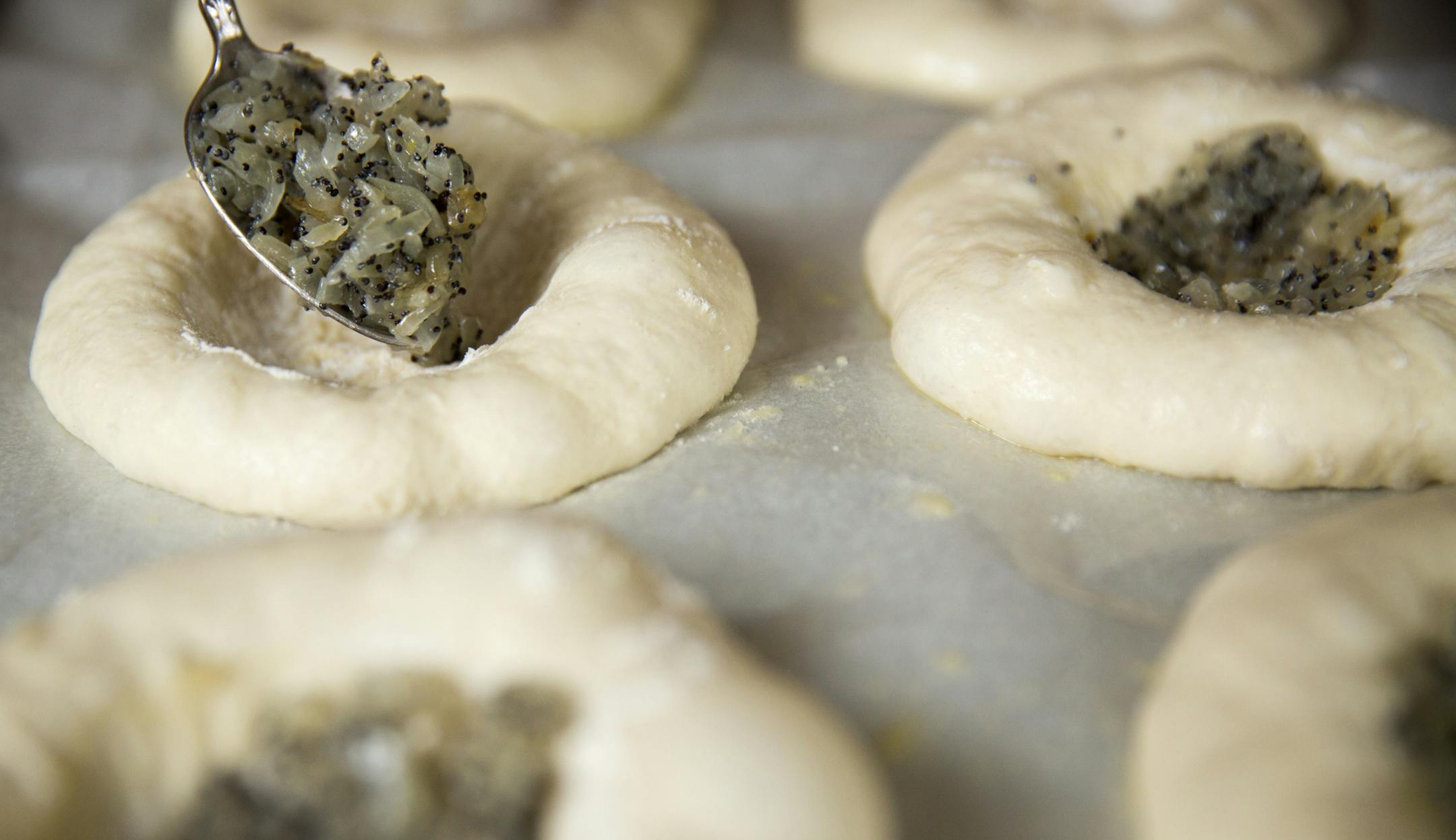 Add the onions and poppyseed to the dough. ] (Leila Navidi/Star Tribune) leila.navidi@startribune.com BACKGROUND INFORMATION: Baking Central makes bialys, an onion and poppyseed filled bread of Eastern European fame, on Thursday, September 15, 2016.