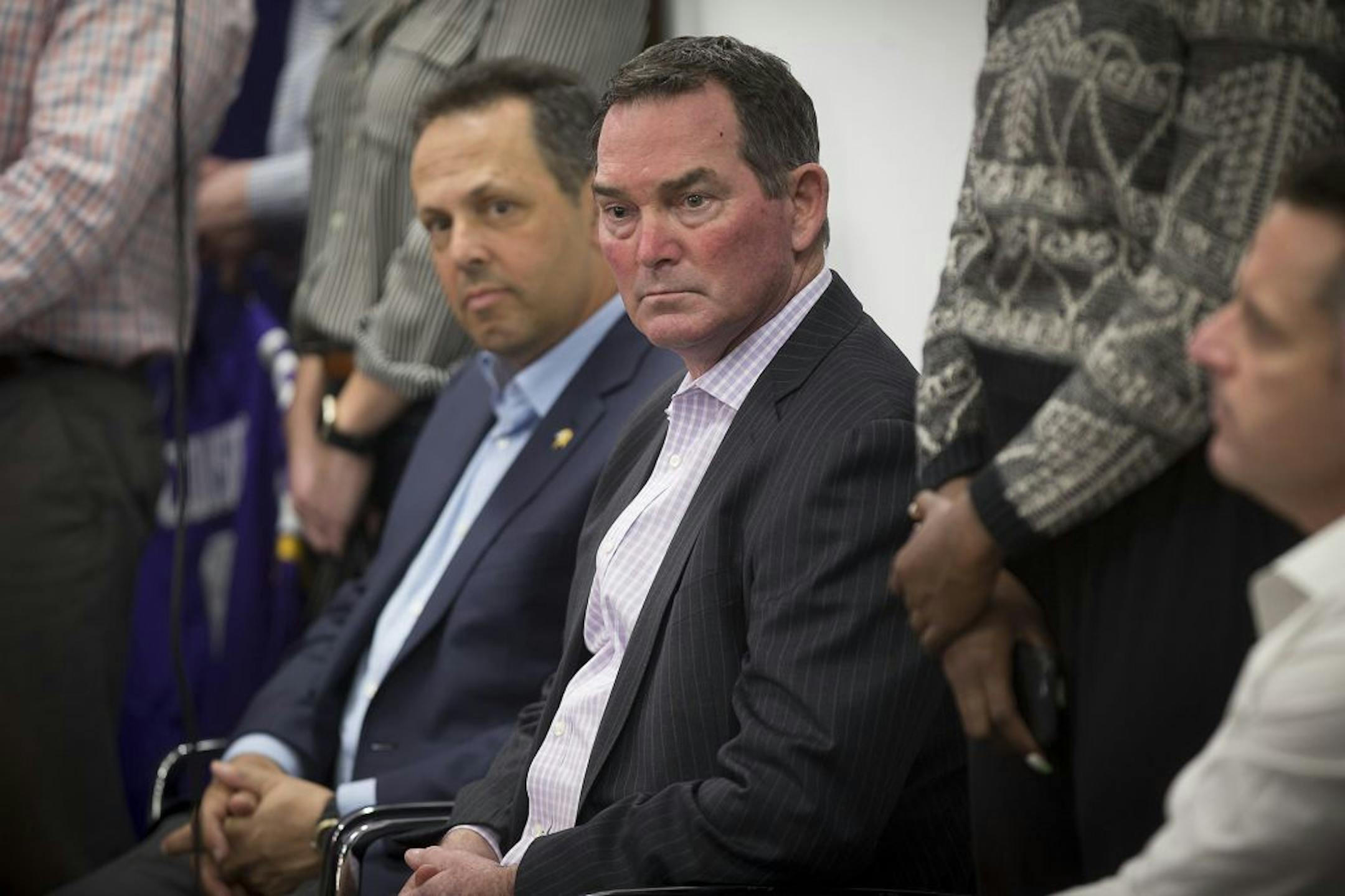Minnesota Vikings Head Coach Mike Zimmer, left, and co-owner Mark Wilf listened to questions addressed to new quarterback Kirk Cousins.