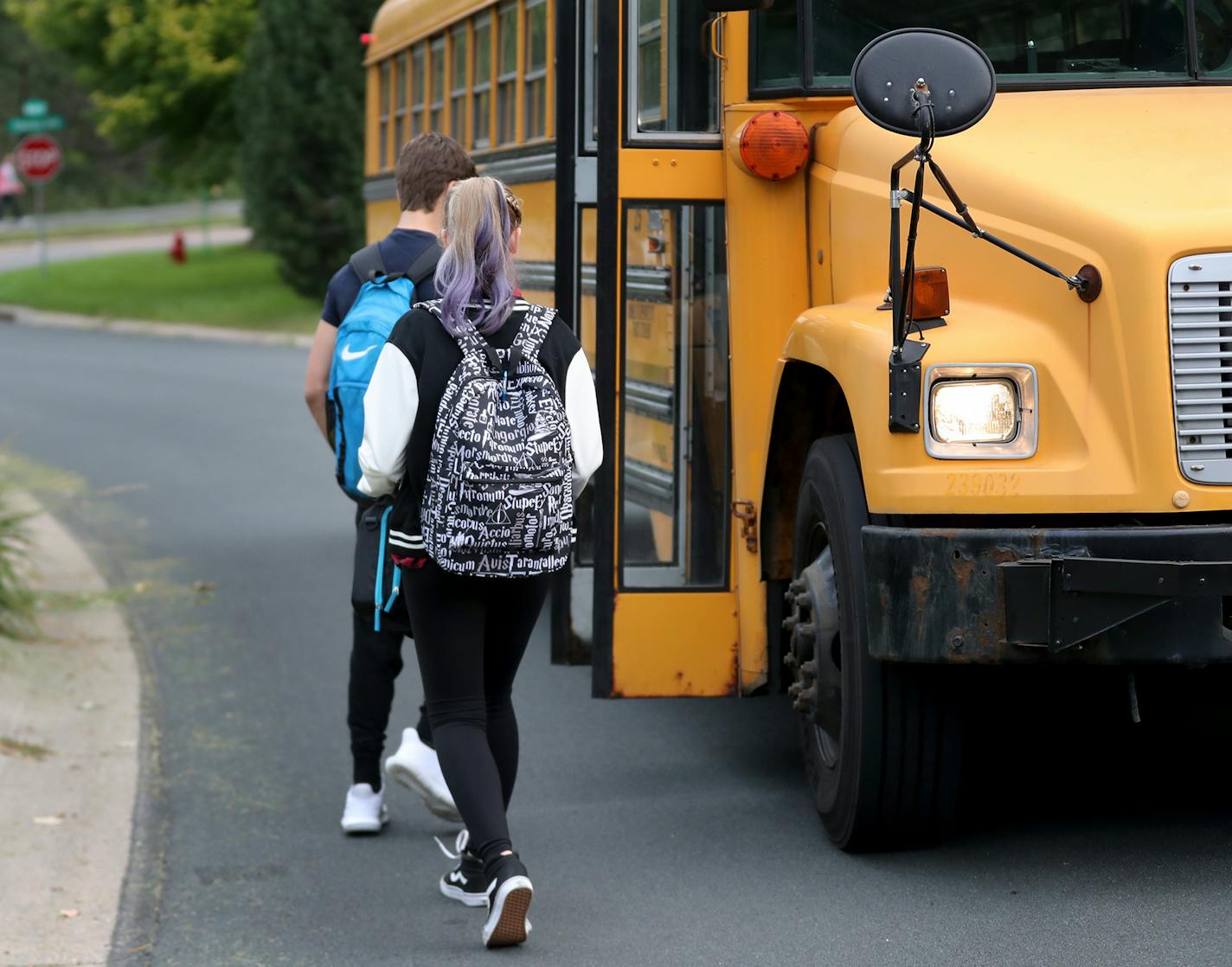 Students board a school bus nicknamed "the secret bus," which takes them from their home in Eden Prairie to school in Minnetonka.