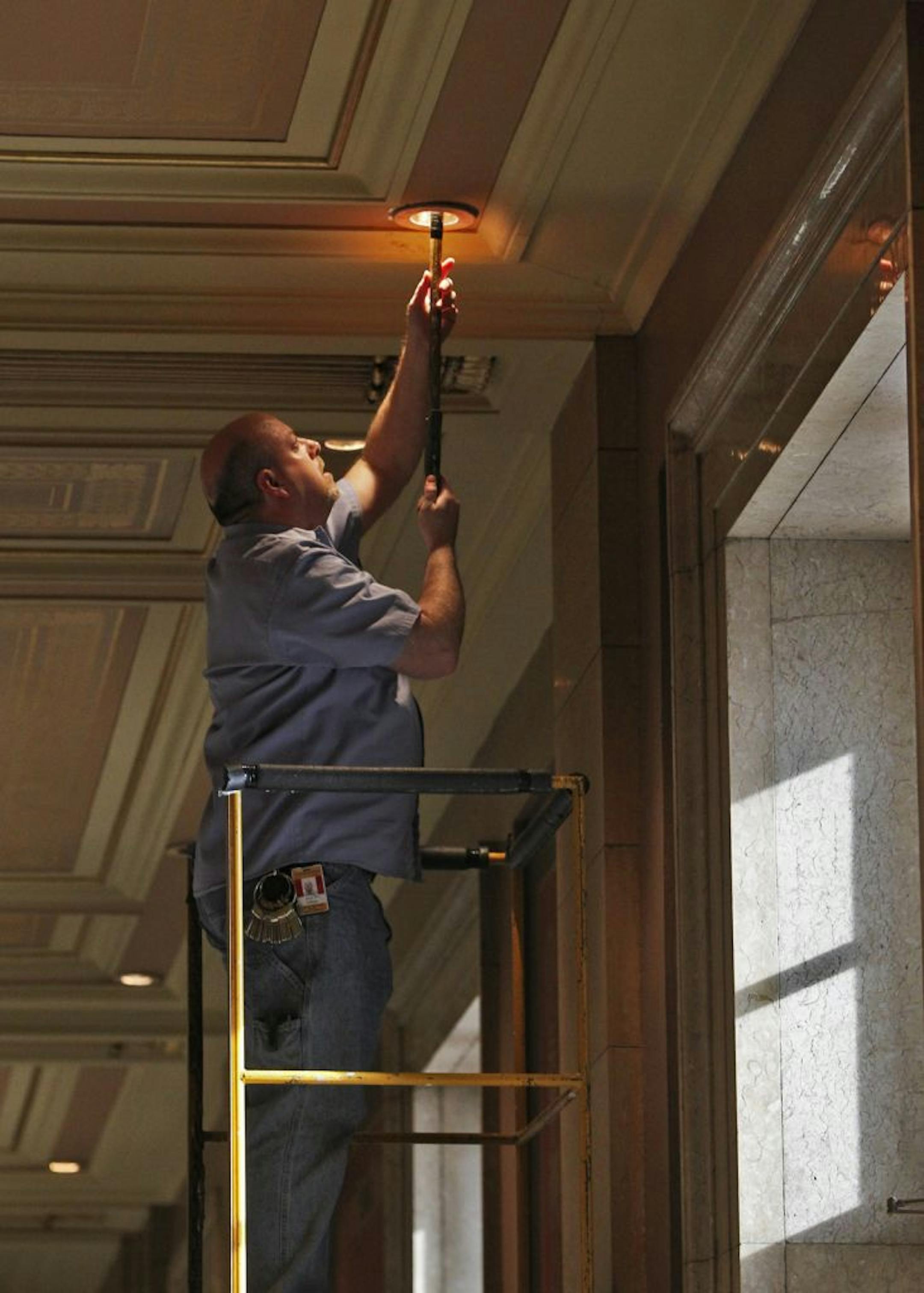 Engineer Dave Albien changed one of the thousands of lightbulbs in the Capitol.