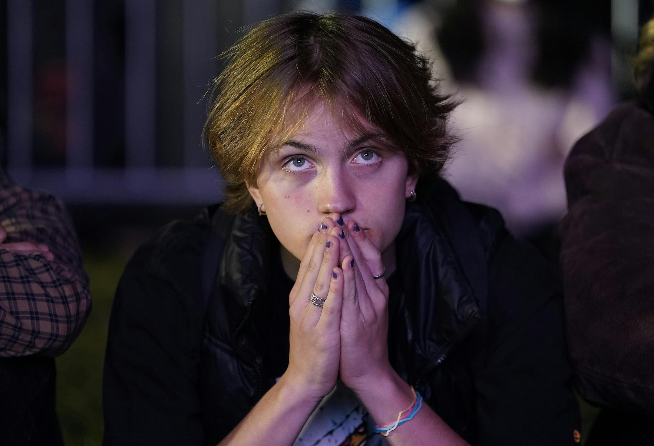 Milo Shea watches local election results at McPherson Square, Tuesday, Nov. 3, 2020, in Washington. (AP Photo/Jacquelyn Martin)