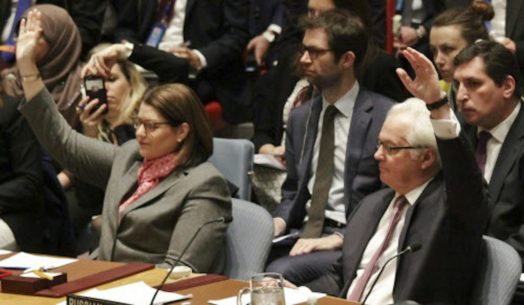 Russian ambassador to the United Nations Vitaly Churkin, right, votes on a resolution during a Security Council meeting at U.N. headquarters, Wednesday, March 2, 2016. The U.N. Security Council has unanimously approved the toughest sanctions on North Korea in two decades. (AP Photo/Bebeto Matthews)