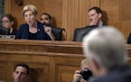 Senate Banking Committee member Sen. Elizabeth Warren, D-Mass., left, questions Wells Fargo Chief Executive Officer John Stumpf, on Capitol Hill in Wa