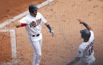 Minnesota Twins center fielder Jake Cave (60) celebrated his grand slam in the second inning with Ehire Adrianza (16) at Target Field Sunday August 5,