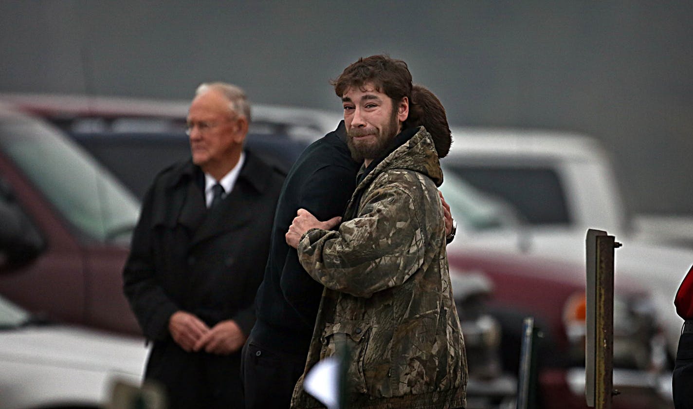 Mourners embraced following the funeral service.