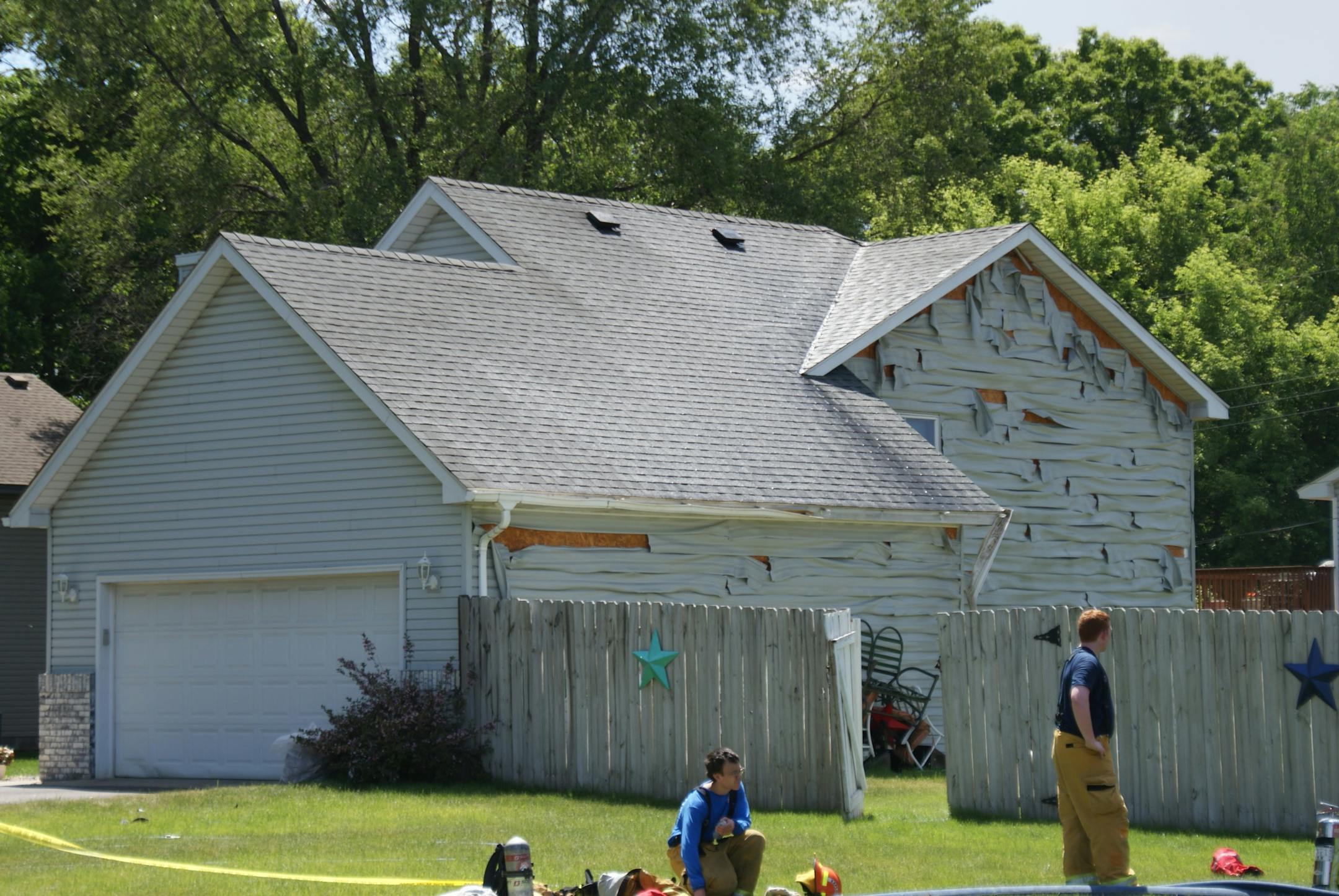 Heat from a fire training exercise in Brooklyn Park causes siding on a nearby house to peel.
