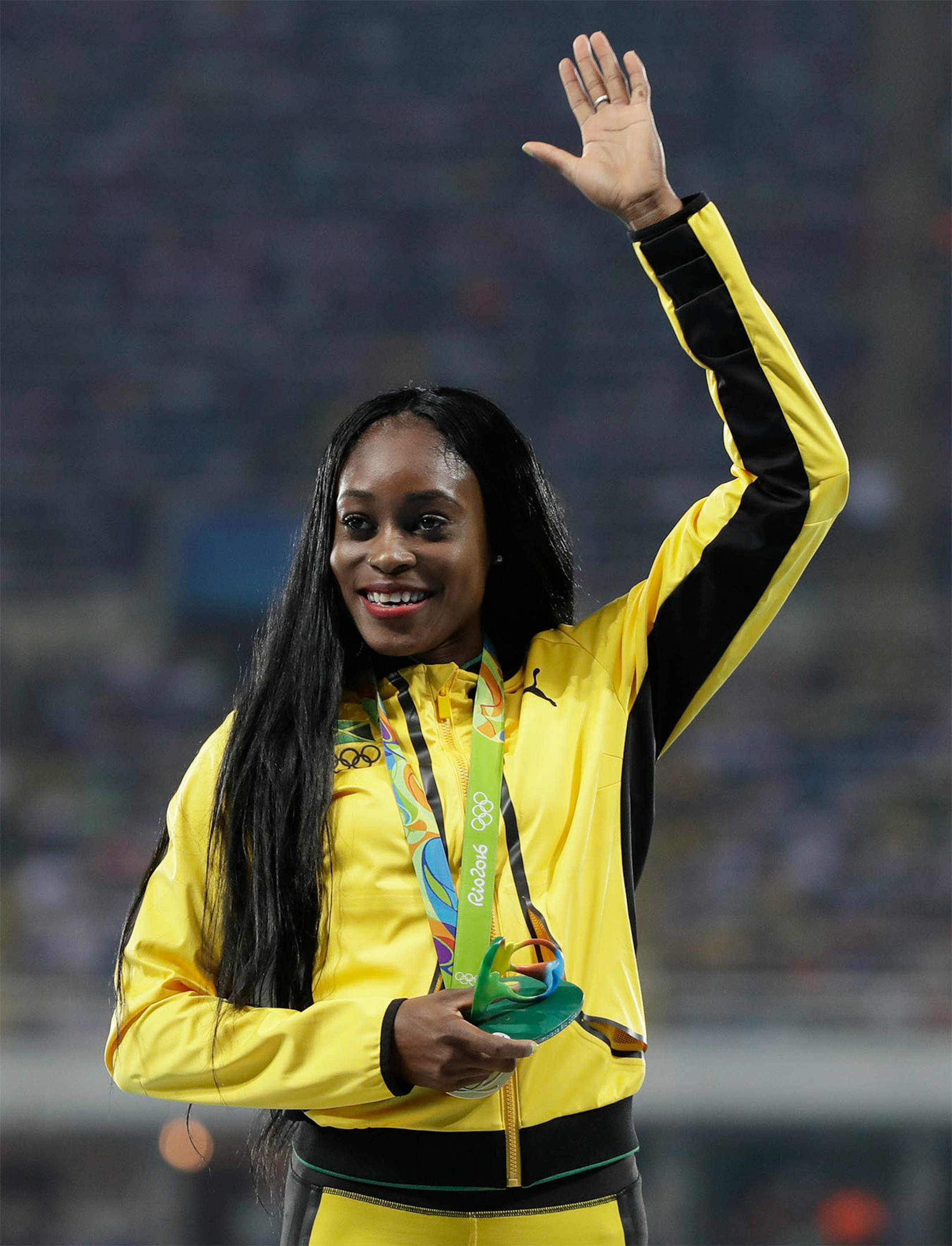 Jamaica's Elaine Thompson celebrates her gold medal for the women's 100-meter final during the athletics competitions of the 2016 Summer Olympics at the Olympic stadium in Rio de Janeiro, Brazil, Sunday, Aug. 14, 2016.