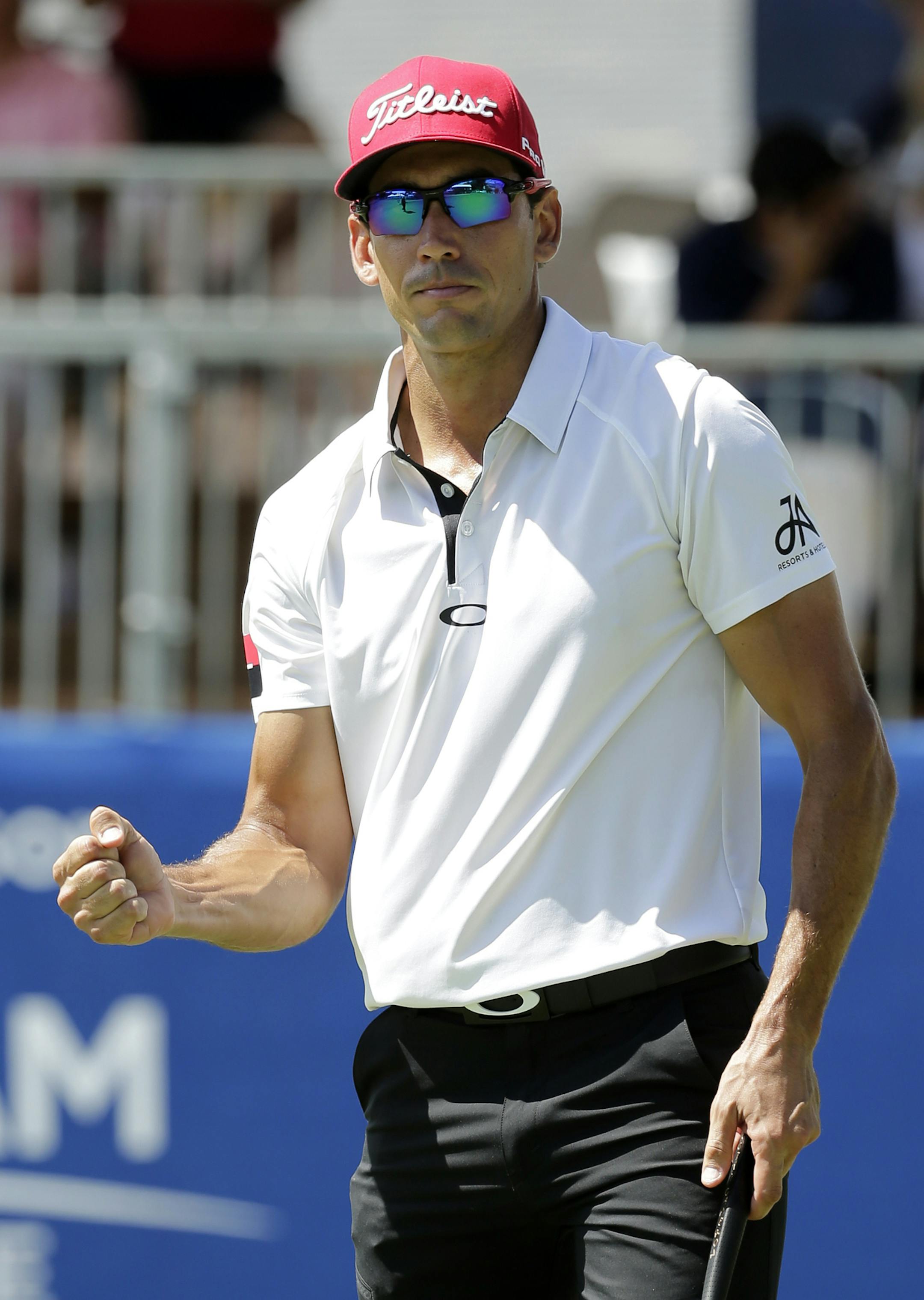 Rafael Cabrera Bello, of Spain, reacts to making a putt on the ninth hole during the first round of the Wyndham Championship golf tournament in Greensboro, N.C., Thursday, Aug. 18, 2016. (AP Photo/Chuck Burton)