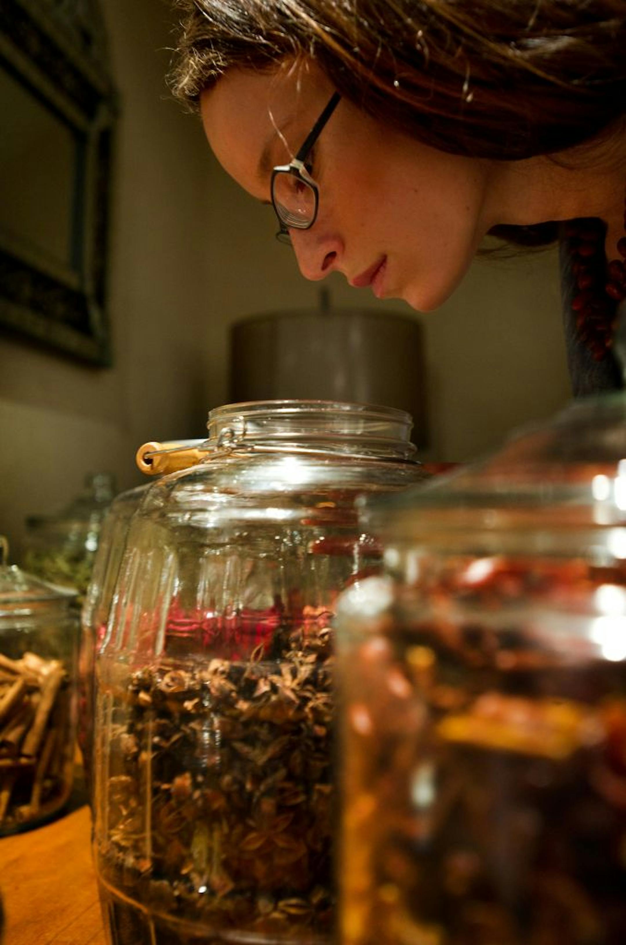 Molly Birnbaum, a food blogger and author of "Season to Taste: How I Lost My Sense of Smell and Found My Way," smells star of anise in the spice room at Junoon, an Indian restaurant, in New York.