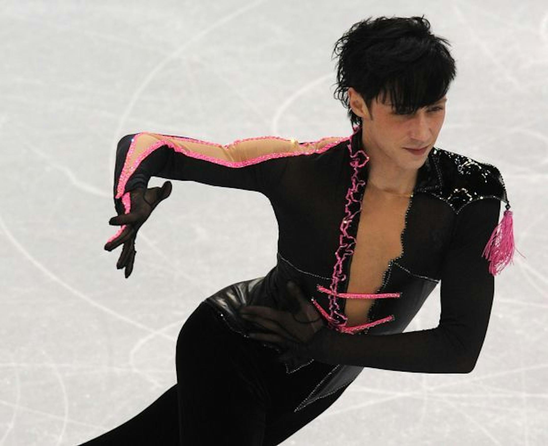 Bad-boy Johnny Weir dared a deep scoop, pink ribbons and a shoulder tassle. Earlier, he fended off threats from anti-fur activists.