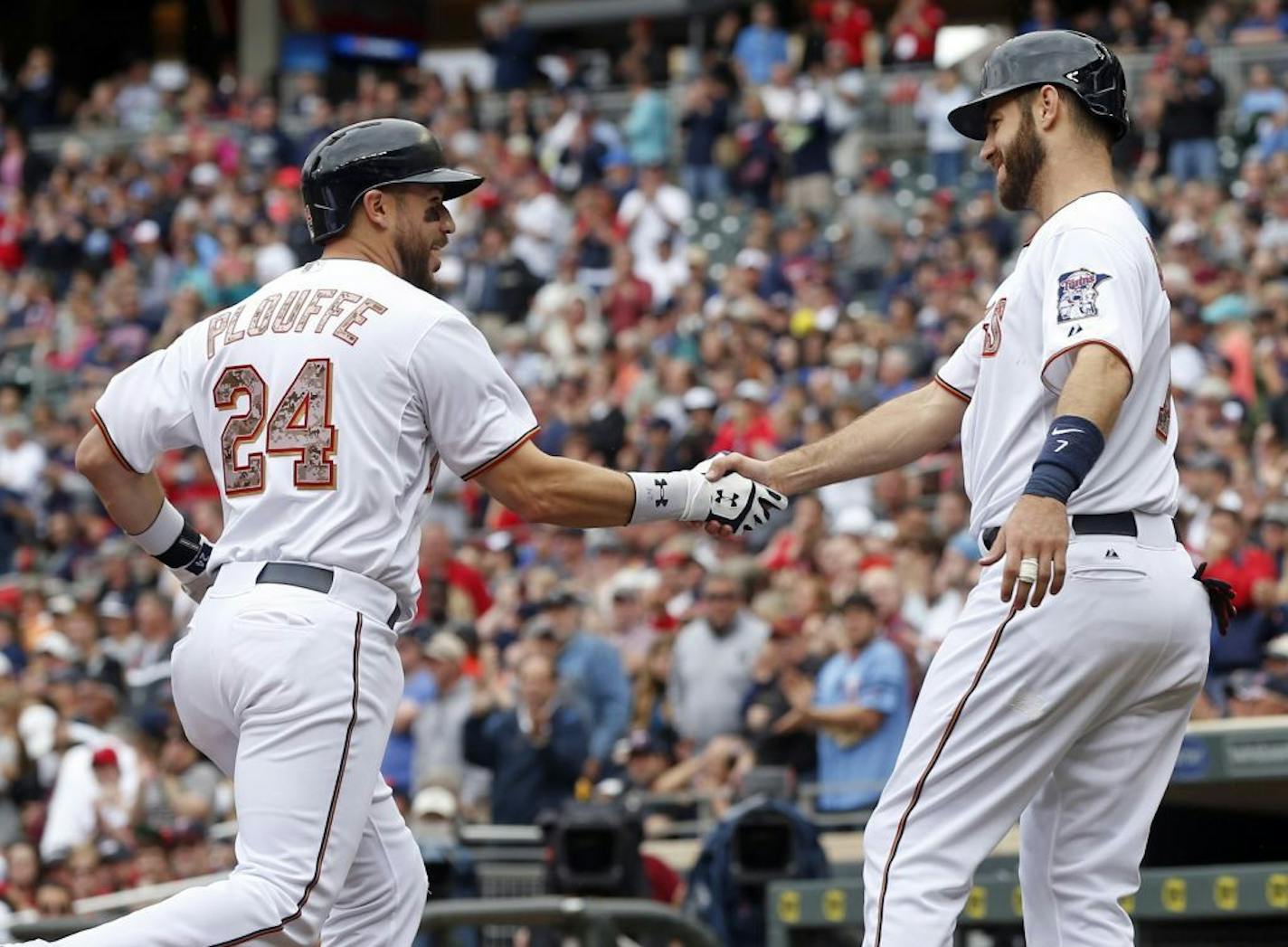 Trevor Plouffe, left, is congratulated by Joe Mauer after Plouffe's three-run home run off Boston Red Sox pitcher Joe Kelly in the second inning of a baseball game, Monday, May 25, 2015, in Minneapolis.