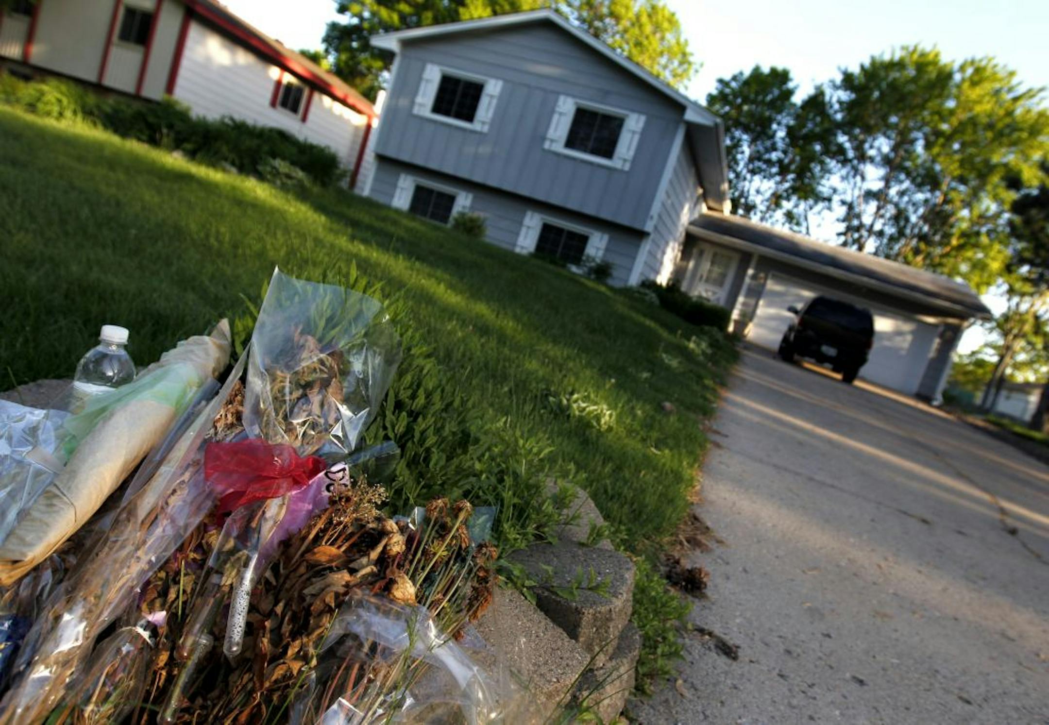 Dried up flowers lay in at the bottom of the mailbox of the Brooklyn Park home on 8117 College Park Drive where a triple homicide occurred on April 9, 2012.