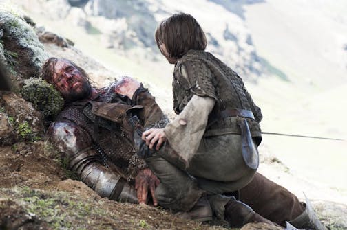 An injured Sandor Clegane, better known as The Hound, portrayed by Rory McCann, left, and Arya Stark, portrayed by Maisie Williams, appear in a scene from season four of "Game of Thrones." The season five premiere airs on Sunday.