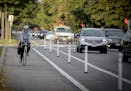 A bicyclist made her way down the bike lane during rush hour near Blaisdell Avenue and 26th Street, Friday, October 13, 2017 in Minneapolis, MN. New b