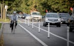 A bicyclist made her way down the bike lane during rush hour near Blaisdell Avenue and 26th Street, Friday, October 13, 2017 in Minneapolis, MN. New b