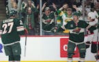 Wild centers Jacob Lucchini (27) and Vinni Lettieri celebrate Lettieri's winning goal during the third period at Xcel Energy Center on Tuesday.