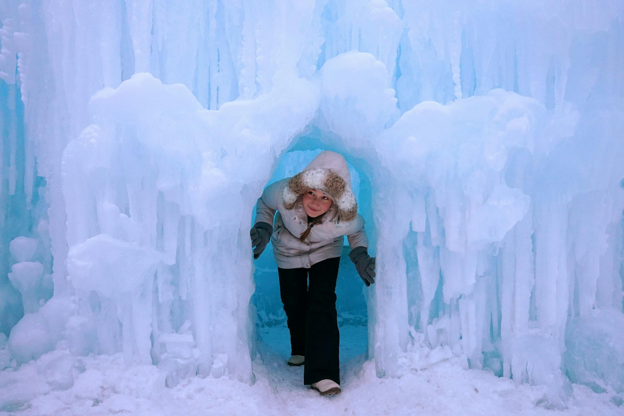 Zhenya Ratushko, 15, of Rochester, Minn. climbed out of an ice cave while exploring the Ice Castle Friday evening Excelsior.