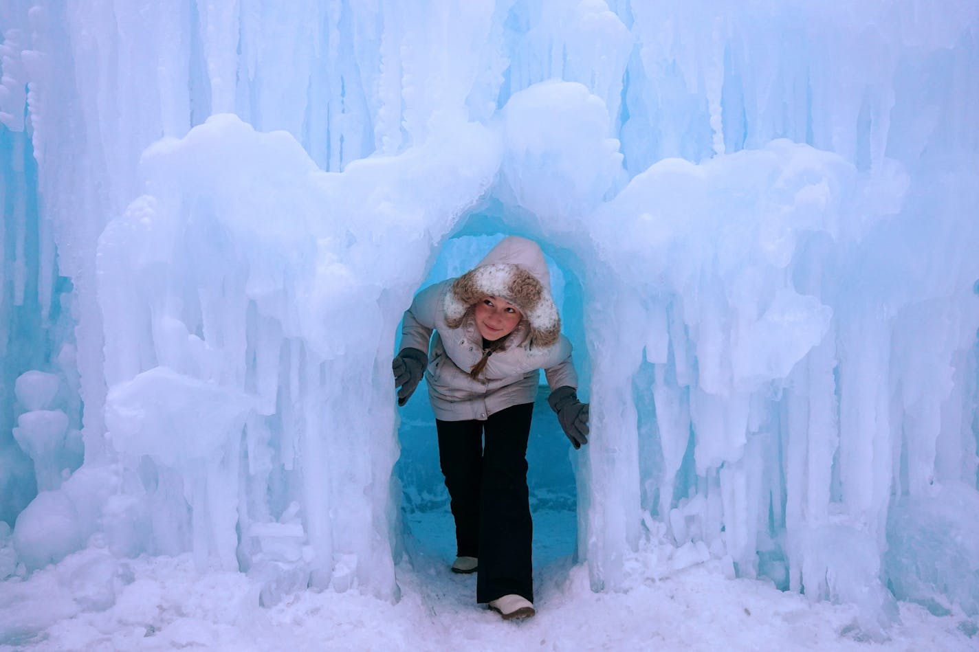 Zhenya Ratushko, 15, of Rochester, Minn. climbed out of an ice cave while exploring the Ice Castle Friday evening Excelsior.