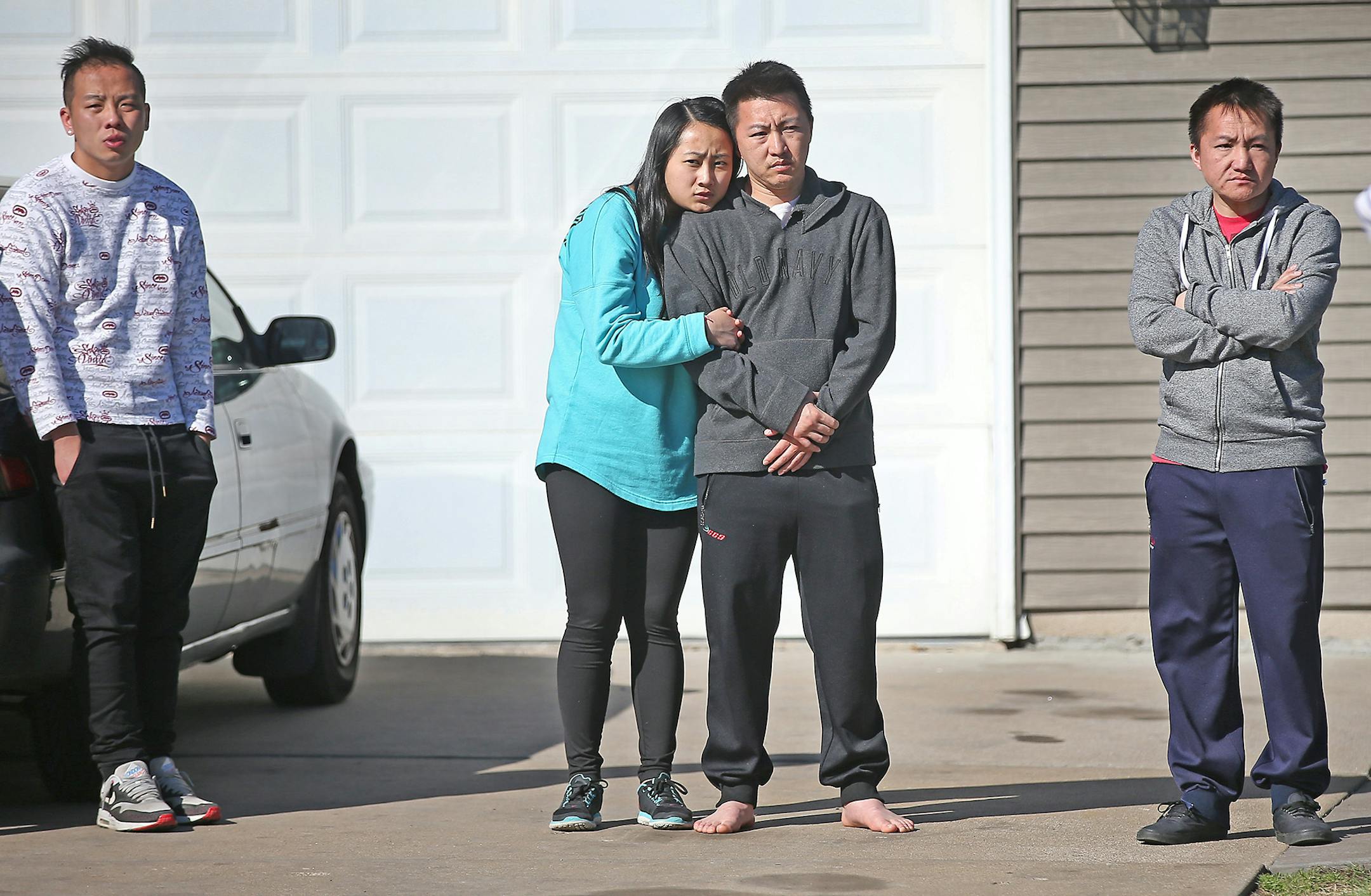 Family members wept outside a home near the site of a boating accident, Sunday, April 26, 2015 in Vadnais Heights.