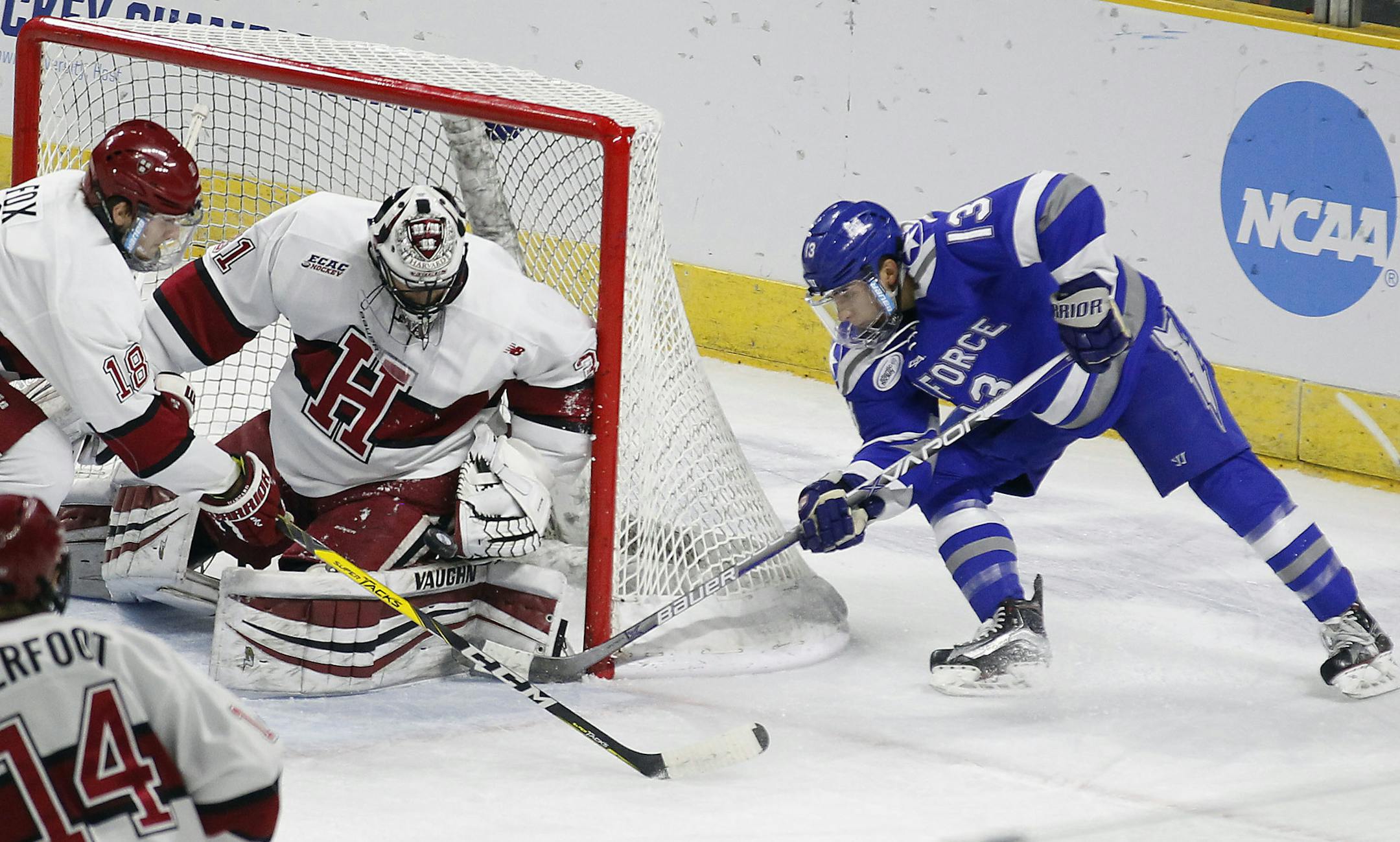 Air Force's Tyler Ledford (13) shoots on Harvard goalie Merrick Madsen (31) during the first period of an NCAA regional men's college hockey tournament game, Saturday, March 25, 2017 in Providence, R.I. (AP Photo/Stew Milne)