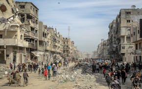 Palestinians gather in a street as humanitarian aid is airdropped in Gaza City on March 1, 2024, amid the ongoing conflict between Israel and the Hama