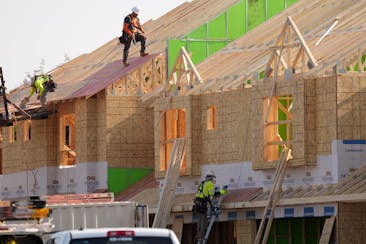 Construction crews work to complete units at the Lennar at Lynwood housing development in Ramsey on Tuesday. Last month, Twin Cities house closings we