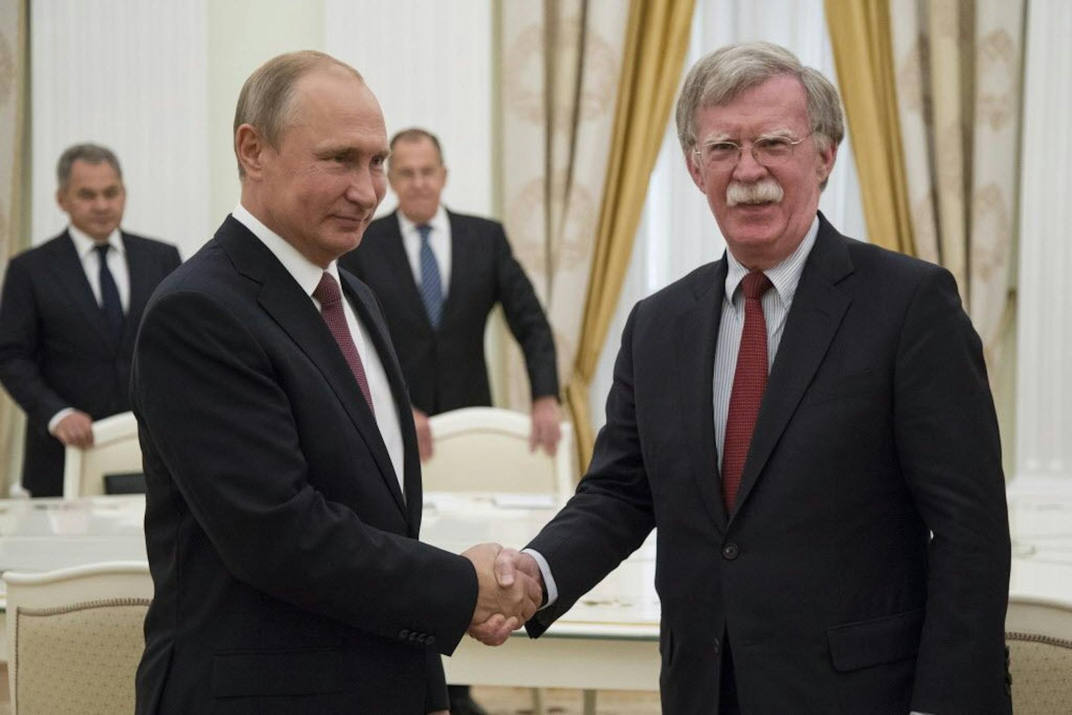 Russian President Vladimir Putin, left, shakes hands with U.S. National security adviser John Bolton during their meeting in the Kremlin in Moscow, Russia, Wednesday, June 27, 2018. U.S. President Donald Trump's national security adviser is due in Moscow Wednesday to lay the groundwork for a possible U.S.-Russia summit.