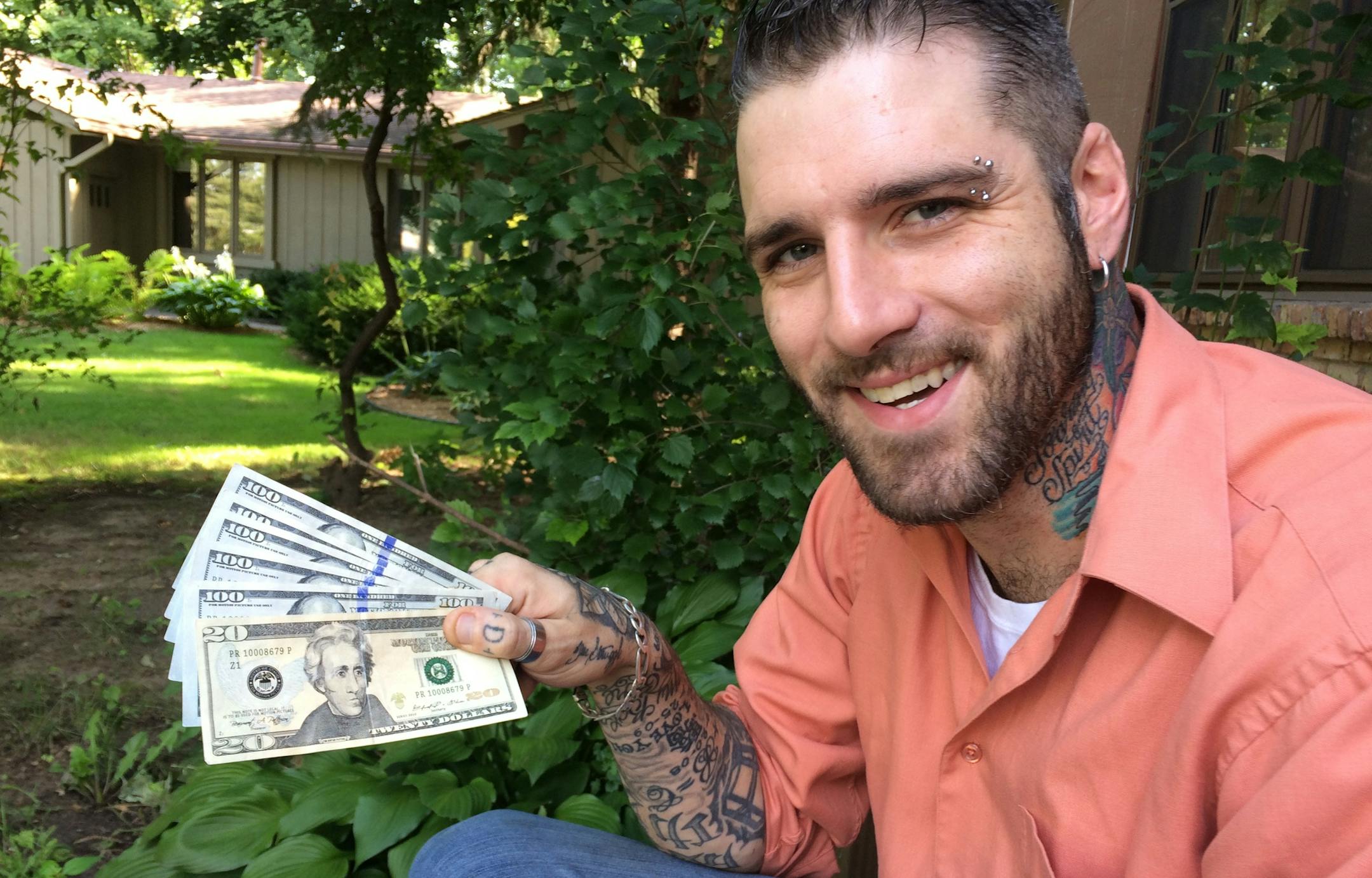 Anthony Darst holds the six realistic-looking but definitely phony banknotes that a thief gave him in June.